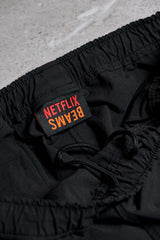 NETFLIX × BEAMS ナイロン トラックパンツ